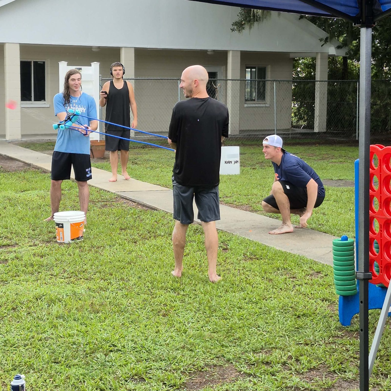 A group gathered around a giant slingshot game during fun events