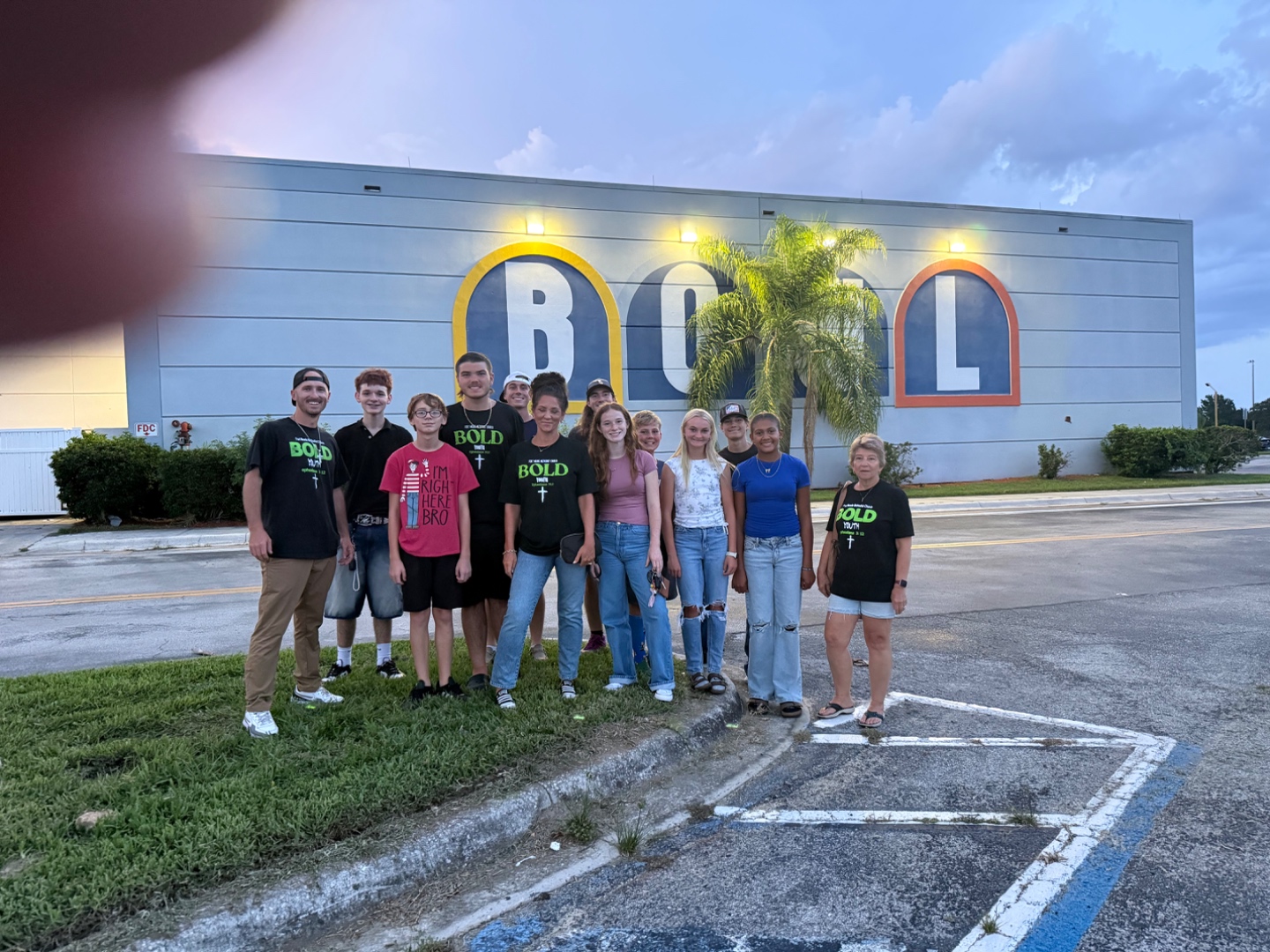 Bold Youth students and leaders posing outside a bowling alley on game night