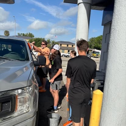 Bold Youth students washing a truck at a car wash fundraiser