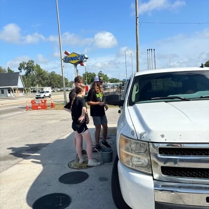 Students washing a car at a service project car wash