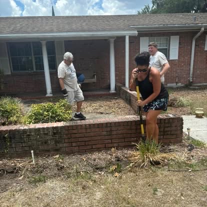 Students doing yard work and landscaping at a service project