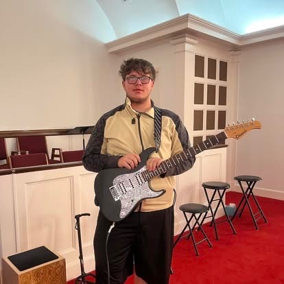 A Bold Youth student playing electric guitar during worship night